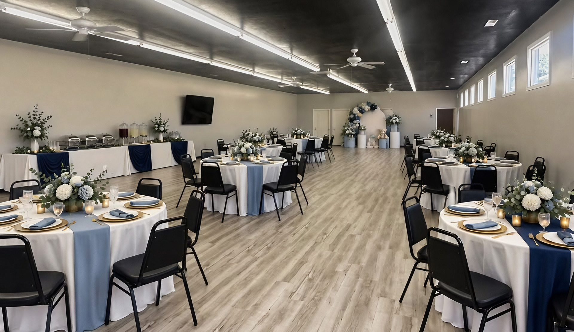 Tables with blue cloths set for a dinner